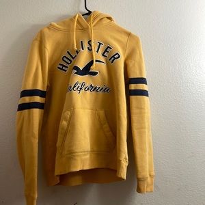 Dark blue and yellow medium sized Hollister hoodie.